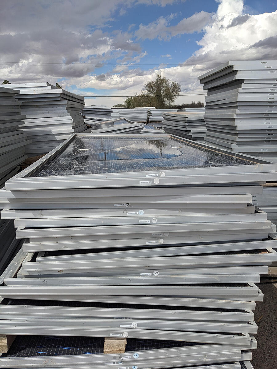 Stacks of retired solar panels needing to be recycled